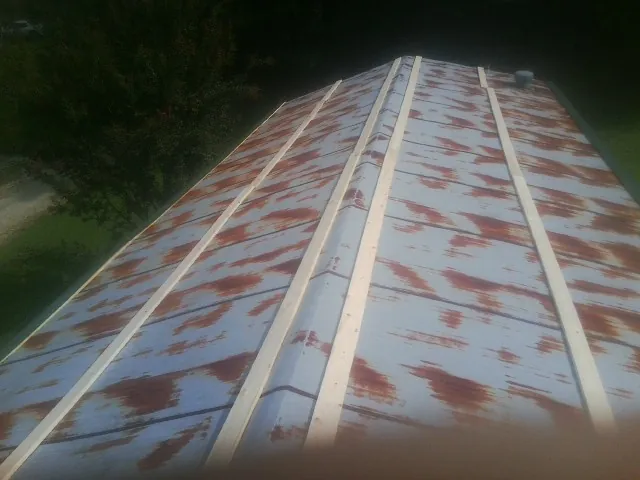 Rusted metal roof panels with new wood purlins before replacement — Storm Damage Roof Repair in Poplar Grove by Roofing Brothers